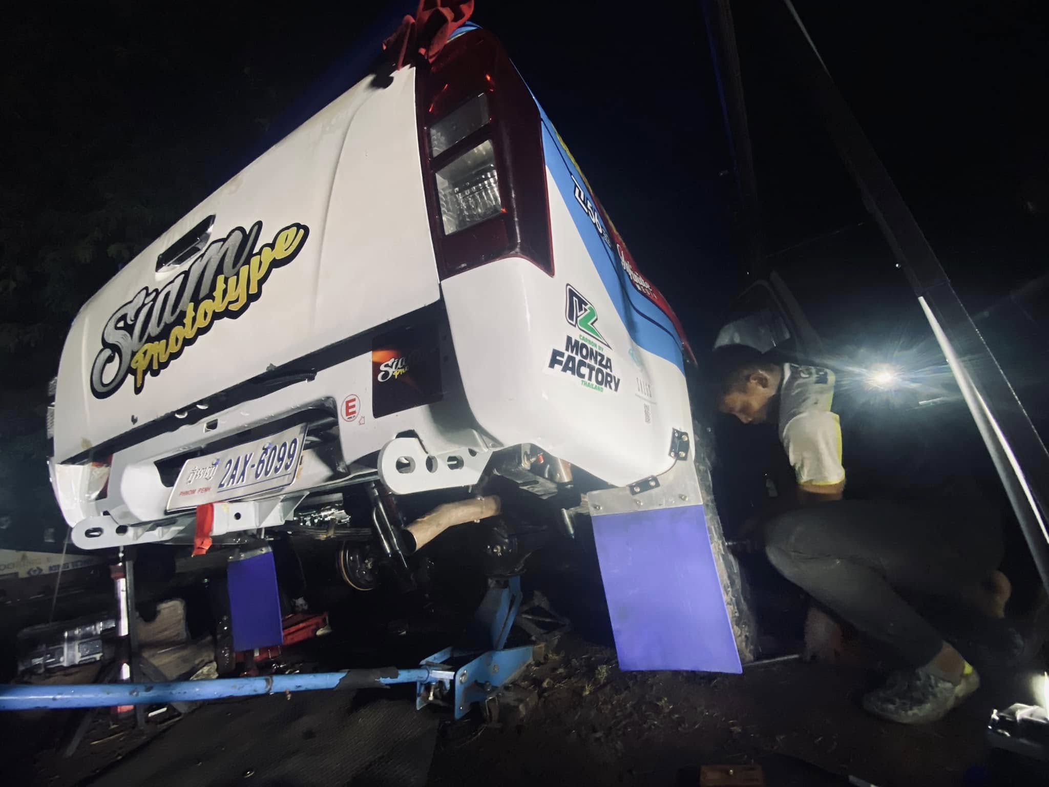 Night service: vehicle on lift under lights