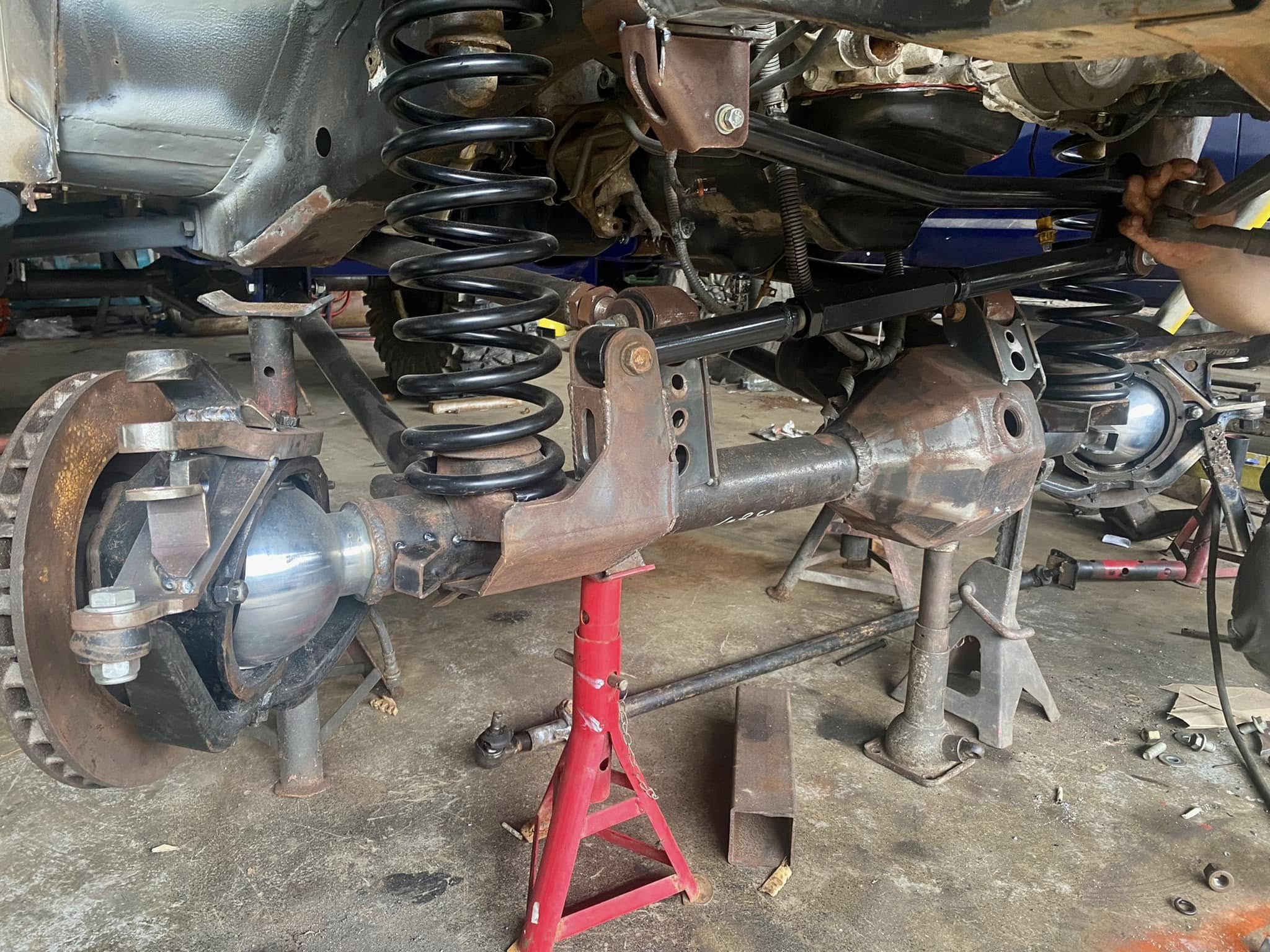Front axle with coil springs