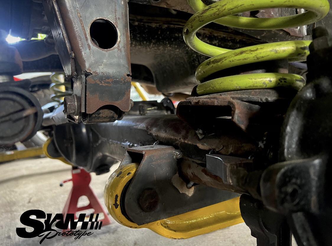 Coil spring installed with custom mounts