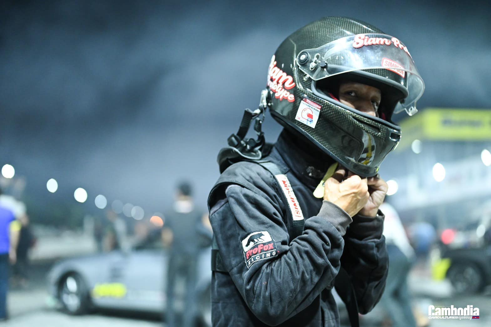 Driver putting on helmet in smoke