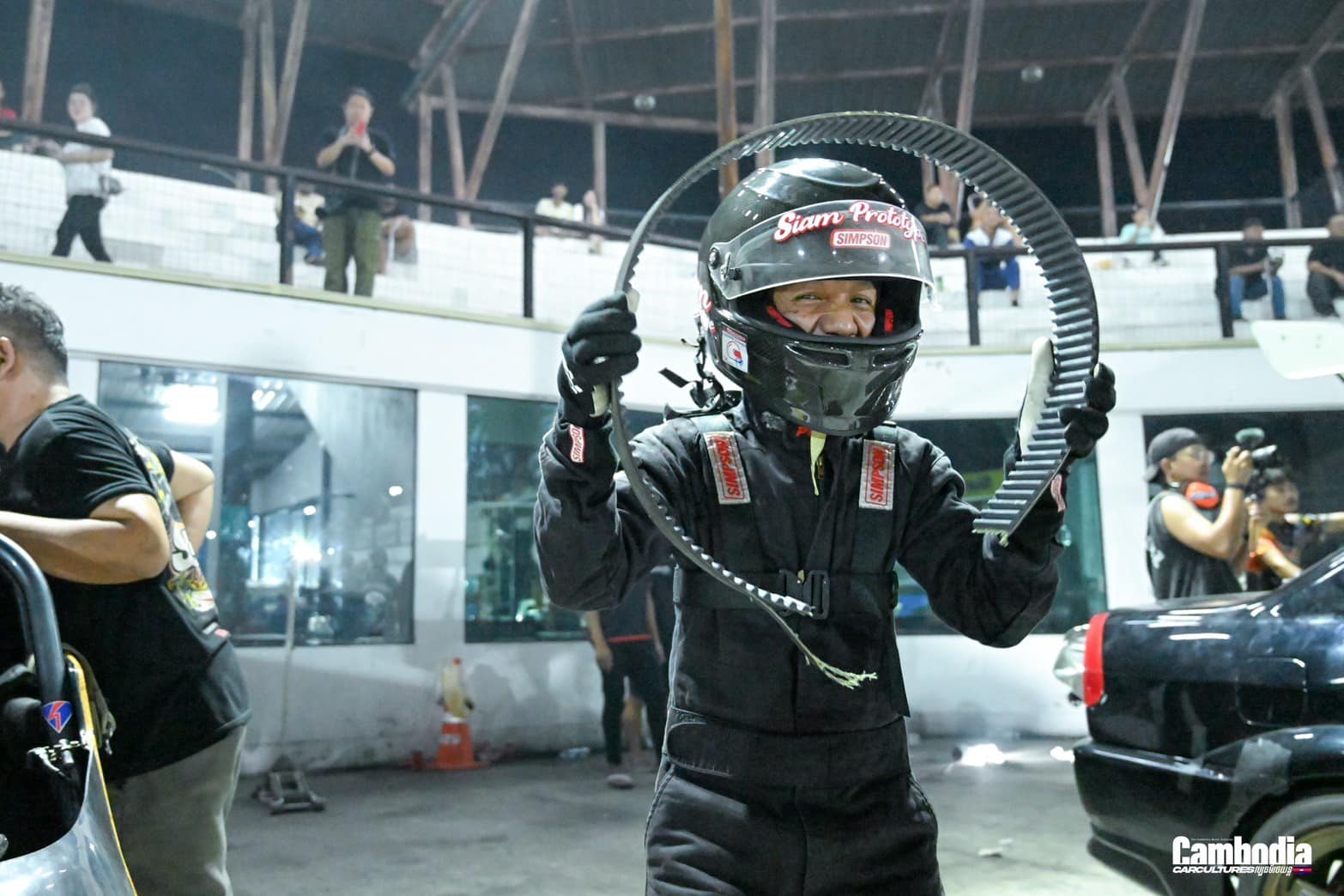 Driver suiting up with HANS device